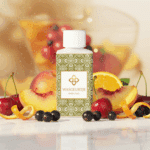 Flesje Wasgeurtje Sweet Fog wasparfum tussen perziken, sinaasappels, kersen en bessen met gouden sprankeling — een levendig beeld dat de fruitige en zoete geurtonen van deze wasparfum benadrukt.